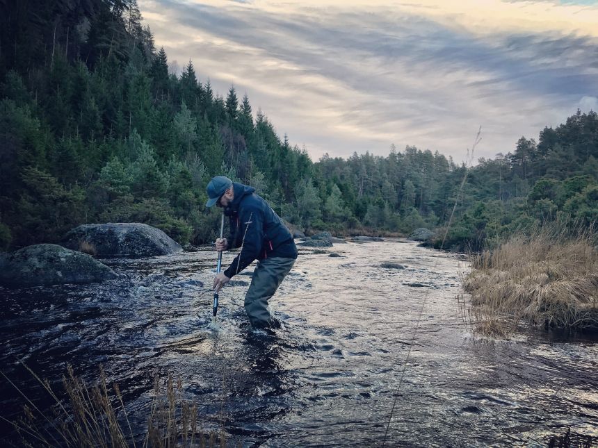 Person in river doing field work