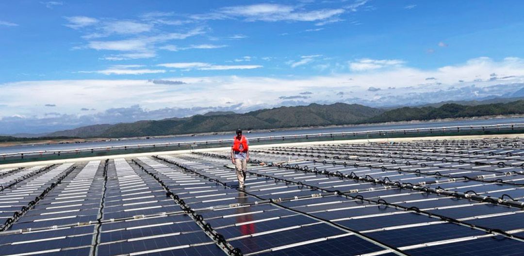 Person walks on area covered by solar panels