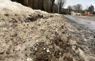 Dirty snow on the side of the road.