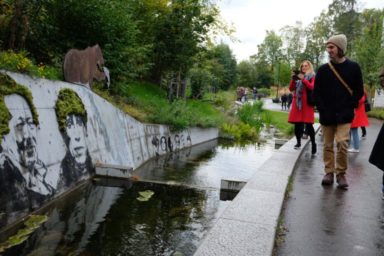 a river with people walking by