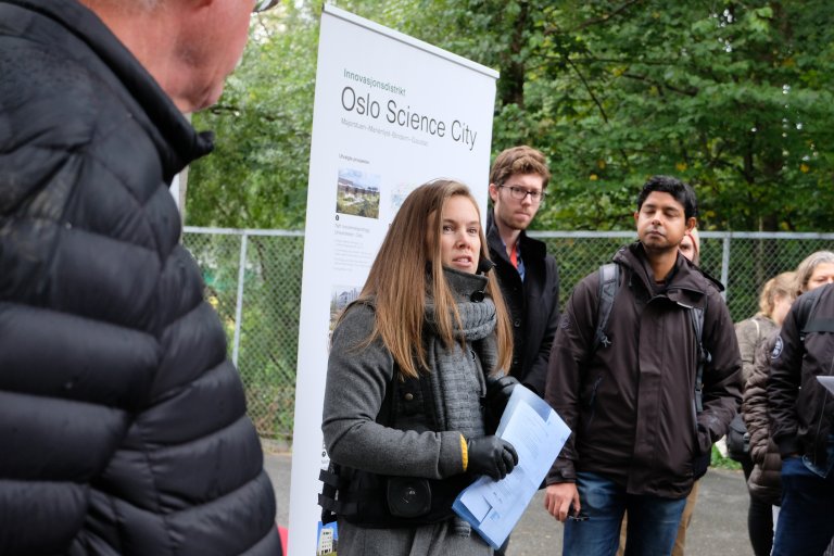 woman lecturing, people listening