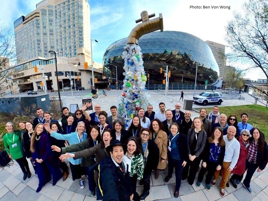 Members of the Scientists’ Coalition in front of “The Tap”, an art installation created by Canadian artist Ben Von Wong.