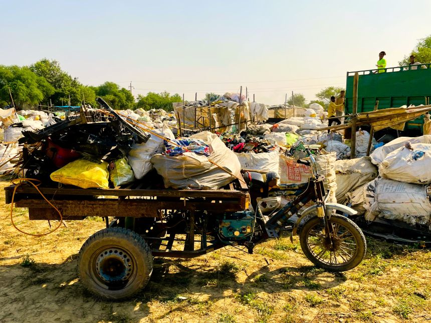 Trisycle loaded with plastic scraps at informal recycling station